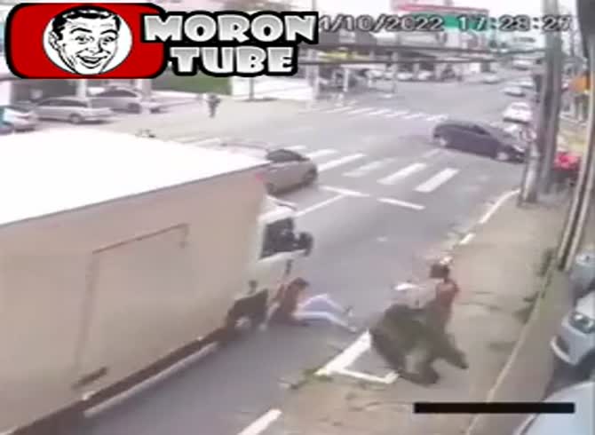 Video :A homeless man nearly gets driven over as he pushes a bystander on the street without cause